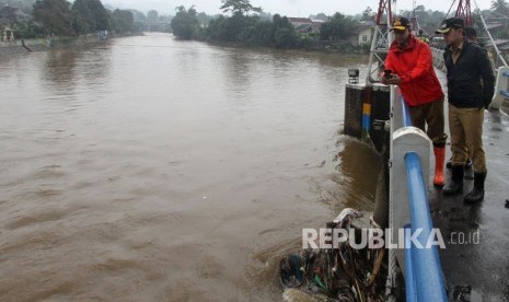 Gubernur Jakarta Anies Baswedan (kiri) didampingi Wali Kota Bogor Bima Arya (kanan) mengunjungi Bendung Katulampa, di Bogor, Jawa Barat, Senin (12/2).