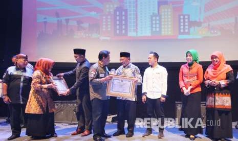 Gubernur Jawa Barat Ridwan Kamil (berjas hitam) dan Pj Wali Kota Bandung Oded M Danial (berbatik) memberikan penghargaan kepada kecamatan yang berpresatasi pada Gelar Pemberdayaan Masyarakat Kota Bandung 2018, di Gedung Sabuga, Kota Bandung, Kamis (13/9).