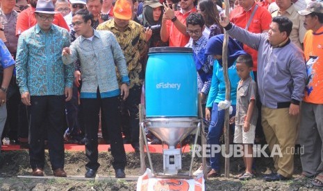 Gubernur Jawa Barat Ridwan Kamil (kiri) bersama Chief Executive Officer Efishery Gibran Huzaifah (kanan) melihat proses pemberian pakan dengan mesin automatic fish feeder saat peluncuran program Kampung Perikanan Digital di Losarang, Indramayu, Jawa Barat