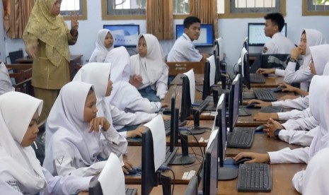 Kemendikbud Yakin Kepala Sekolah Patuhi Regulasi Dana BOS. Foto: Guru mengajar di kelas. (Ilustrasi)