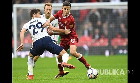 Pemain Tottenham Hotspur Harry Winks (kiri) berebut bola dengan pemain Liverpool Philippe Coutinho (kanan) pada pertandingan Liga Primer Inggris di Wembley, Inggris