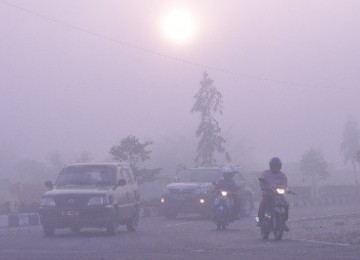 Haze limits visibility in some area in Indonesia forest fire or land clearing using fire, last year.