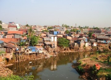 Housing in the slums on the banks of the Ciliwung river (illustration).