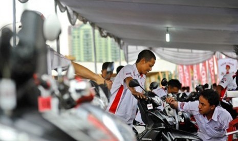 Ilustrasi servis sepeda motor Honda.