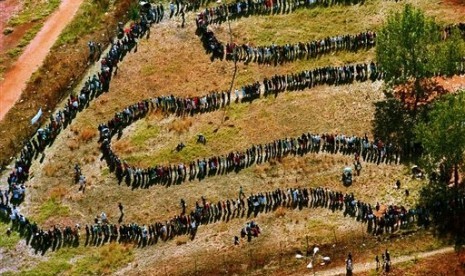 In this April 27, 1994, file photo, a long line of people wait outside the polling station in Soweto to vote in South Africa's first all-race elections. Nelson Mandela then emerged as the first black president in the country. (File photo)