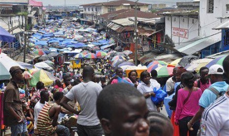 In this Aug. 19, 2014 file photo, people do business at the Waterside local market in the center of Monrovia, Liberia.