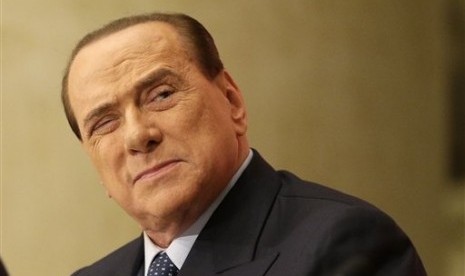 In this Dec. 4, 2013 photo former Premier Silvio Berlusconi attends the launch of a book 