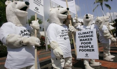 In this Dec. 6, 2007, file photo, Oxfam activists wearing polar bear costumes stage a demonstration outside the venue of the UN climate change conference in Nusa Dua, Bali island, Indonesia. 