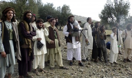 In this file image taken on Oct. 4, 2009, Pakistan's new Taliban leader Hakimullah Mehsud, center, operates light machine gun with his comrades in Sararogha in Pakistani tribal area of South Waziristan along Afghanistan border. Intelligence officials said 