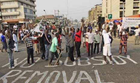 In this Friday, Jan. 13, 2012 file photo, People protest on a sign written on a major road saying' No subsidy removal' in Lagos, Nigeria.