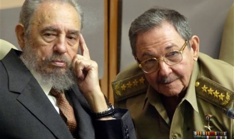 In this July 31, 2004 file photo, Cuba's President Fidel Castro (left) and his brother, Minister of Defense Raul Castro, attend a Parliament session in Havana, Cuba. 