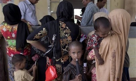 In this June 25 2014 file photo, Rohingya refugees gather to receive medicine at Dar Paing village clinic, north of Sittwe, Rakhine state, Myanmar. 