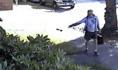 In this June 7, 2014 file image from from a security video provided by Philip Lao, shows Dennis Kneier, the mayor of San Marino, Calif., tosses a bag of dog waste onto the property of his Lao, in San Marino, Calif. 