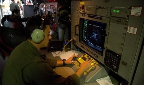 In this march 27 photo, Sgt. Matthew Falanga, an airborne electronics analyst, observes a radar image aboard a Royal Australian Air Force AP-3C Orion aircraft 