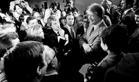 In this March 9, 1977 file photo, President Jimmy Carter (right) is at a news conference where he announced the lifting of the travel ban on Cuba, Vietnam, North Korea and Cambodia, in the executive office building in Washington, DC. 