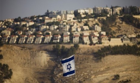 In Monday, Sept. 7, 2009 a file photo of an Israeli flag is seen in front of the West Bank Jewish settlement of Maaleh Adumim on the outskirts of Jerusalem. 