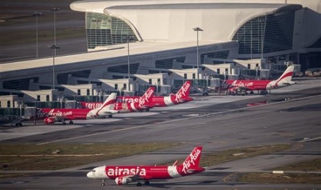 In this Nov 26, 2014 photo, AirAsia Airbus A320-200 passenger jets are seen on the tarmac at low cost terminal KLIA2 in Sepang, Malaysia.