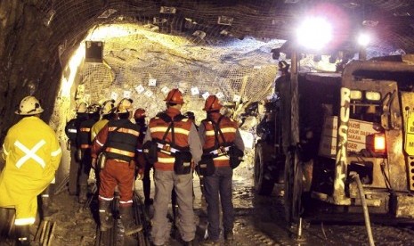 In this photo taken and released by PT Freeport Indonesia, on May 17, 2013, the Indonesian unit of Arizona-based Freeport-McMoRan Copper & Gold Inc, rescuers gather inside a tunnel that collapsed in May.