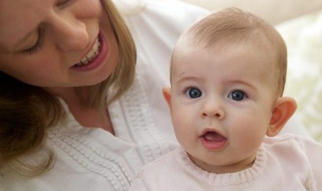 In this photo taken Sept. 24, 2013, Holly Sloan interacts with her baby Amelia at their home in Warrenton, Va. Ameliaís family enrolled in a study that is deciding the DNA of babies, as researchers explore whether gene-mapping one day should become a part 