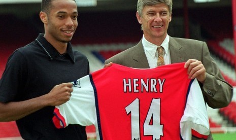 In this Tuesday, August 3, 1999 file photo Arsenal's latest signing, Thierry Henry, left, with Manager Arsene Wenger, pictured at Highbury in north London. Thierry Henry has announced his retirement following a 20-year career. The 37-year-old Henry, a memb