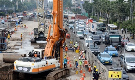 Infrastruktur Transportasi Massal: Pekerja menyelesaikan proyek pembangunan Mass Rapid Transit (MRT) di Jalan MH. Thamrin, Jakarta, Kamis (26/2). 