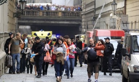 Injured people leave a scene of an explosion in downtown Prague, Czech Republic, Monday, April 29, 2013. 