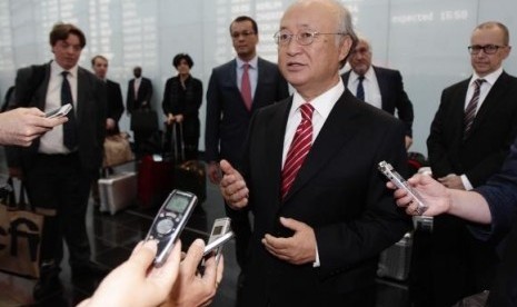 International Atomic Energy Agency (IAEA) Director General Yukiya Amano talks to the media as he arrives at Vienna's airport August 18, 2014.