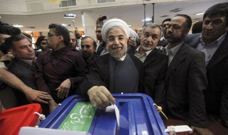 Iranian presidential candidate Hasan Rowhani, the country's former top nuclear negotiator, casts his ballot in the presidential election at a polling station in downtown Tehran, Iran, Friday, June 14, 2013. 