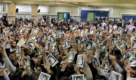 Iranian well wishers attending the speech of Supreme Leader Ayatollah Ali Khamenei hold up his picture at a mosque inside the leader's housing compound in Tehran, Iran, Saturday.