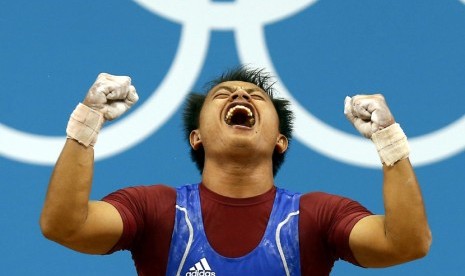  Jadi Setiadi bereaksi usai mengangkat beban saat berkompetisi pada cabang angkat besi Grup B kelas 56 kg di Olimpiade London di Excel, Ahad (29/7). (Dominic Ebenbichler/Reuters)