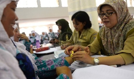  Jamaah calon haji Kloter 7 dari Tangerang menjalani pemeriksaan oleh petugas kesehatan saat tiba di Asrama Haji Pondok Gede, Jakarta, Selasa (25/8).    (Republika/Wihdan)