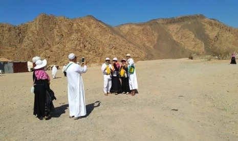 Jamaah haji Indonesia berpose di depan Wadi Al Jinn, Madinah, pekan lalu. Lokasi itu kerap dikunjungi terkait fenomena alamnya. 