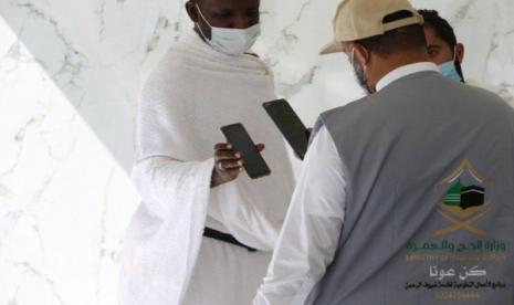 Jamaah mroh mengecek izin masuk ke Masjidil Haram melalui aplikas Eatmarna