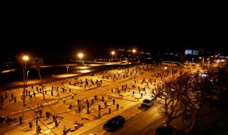 Jamaah sholat tarawih memenuhi lokasi bekas tempat parkir di Jaffa, Israel.  Warga Tel Aviv, Israel berusaha mencari udara panas untuk berjemur. Sebagian besar warga yang berjemur di pantai-pantai Laut Tengah dan Lembah Yordania mempertahankan himbauan pembatasan sosial dan jaga jarak.