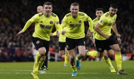 John Fleck melakukan selebrasi usai mencetak gol ke gawang Arsenal.