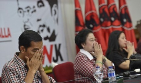 Joko Widodo (kiri) bersama Megawati Sukarnoputri (tengah) dan Puan Maharani (kanan) berdoa bersama sebelum acara rapat koordinasi kampanye Pilpres di Kantor DPP PDI Perjuangan, Lenteng Agung, Jakarta Selatan, Rabu (4/6). 