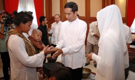  Jokowi bersama istri Iriana Widodo menyalami warga saat open house di rumah dinas, Jakarta Pusat, (ilustrasi).