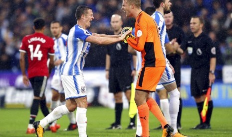 Jonathan Hogg dan penjaga gawang Huddersfield Jonas Lossl setelah mengalahkan Manchester Uniteddi Stadion John Smith Stadium, Huddersfield, Inggris.