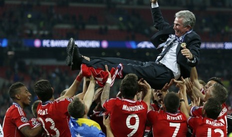 Jupp Heynckes (atas) dielu-elukan para pemainnya usai membawa Bayern Muenchen meraih trofi Liga Champions 2012/2013.