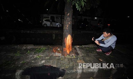 Jurnalis sedang memotret lokasi kejadian kecelakaan Setya Novanto di Jalan Permata Berlina, Jakarta Selatan, Kamis (11/06). Ketua DPR RI  Setya Novanto mengalami kecelekaan yang dikabarkan saat menuju ke kantor KPK.