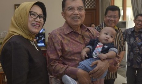 Jusuf Kalla (kedua kiri) bersama Ibu Mufidah Jusuf Kalla (kiri) mengendong Ali cucu ke-11 ketika merayakan hari ulang tahun Jusuf Kalla ke-72 di Jakarta, Kamis (15/5).