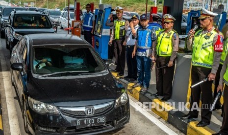 Kakorlantas Polri Irjen Pol Refdi Andri (kanan) secara simbolis memberlakukan satu jalur (one way) di Tol Trans Jawa Km 414 Gerbang Tol Kalikangkung, Semarang, Jawa Tengah, Jumat (7/6/2019).