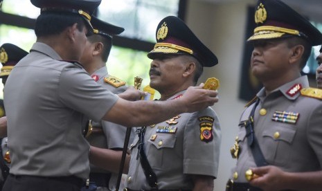 Kapolri Jenderal Pol Badrodin Haiti menyematkan tanda pangkat kepada Kapolda Jawa Barat Irjen Pol Jodie Rooseto (tengah) saat sertijab Perwira Tinggi Polri di Mabes Polri, Jakarta, Senin (21/3). 