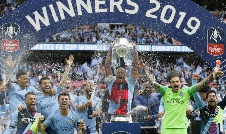 Kapten Manchester City, Vincent Kompany mengangkat trofi Piala FA.