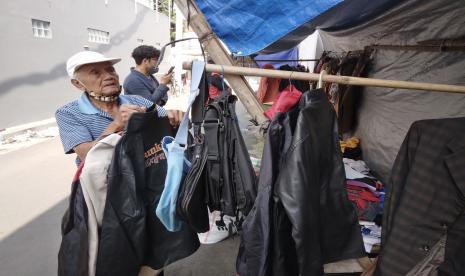 Karto Utomo memajang pakaian bekas di lapaknya.