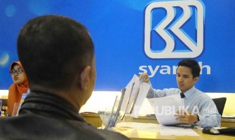 Karyawan melayani nasabah di Banking Hall Bank BRI Syariah, Jakarta.