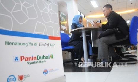 Karyawati melayani nasabah di Banking Hall Bank Panin Dubai Syariah, Jakarta, Senin (29/5).