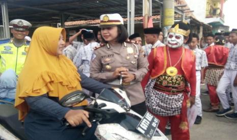 Kasatlantas Polres Demak, AKP Nyi Ayu Fitria Facha memberikan edukasi tertib berlalu lintas kepada wmak- emak pelanggar ketentuan keamanan dan keselamatan berkendara, pada simulasi dan eduksi tertib berlalu lintas, yang dilaksanakan bersama dengan Komunitas Rumah Kita (Koruki) Demak dan Pemerintah Desa Karangsari, Kecamatan Karangtengah, Kabupaten Demak, Rabu (11/3).(Republika/Bowo Pribadi)