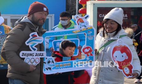 Keluarga foto bersama dengan membawa atribut Olimpiade Musim Dingin 2022 yang disediakan oleh pihak panitia penyelenggara di kawasan Sanlitun, Beijing, China, Senin (31/12022). Olimpiade Musim Dingin Beijing 2022 digelar pada 4-20 Februari 2022 yang bersamaan dengan musim libur panjang Tahun Baru Imlek. 