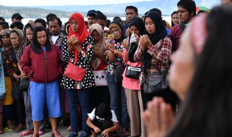 Keluarga korban tenggelamnya KM Sinar Bangun bersama warga mengikuti doa lintas agama di dermaga Tigaras, Danau Toba, Simalungun, Sumatera Utara, Minggu (1/7). 